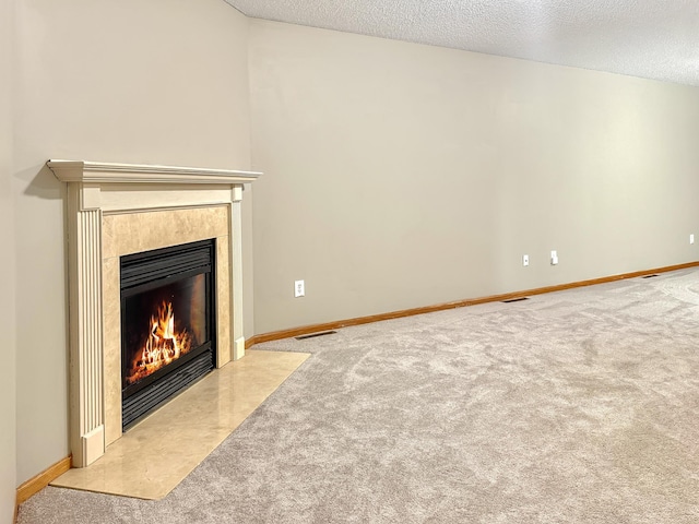 10809 Tyler Ct NE, Blaine, MN 55434 - unfurnished living room featuring a fireplace with flush hearth, carpet flooring, a textured ceiling, and baseboards