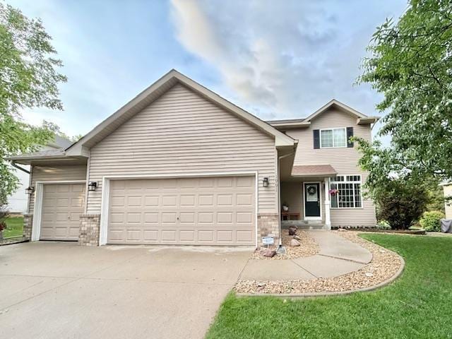 1991 Fountain Ln, Waconia, MN 55387 - traditional home with a garage, concrete driveway, a front yard, and brick siding