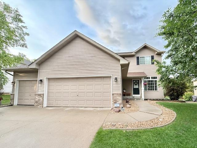 1991 Fountain Ln, Waconia, MN 55387 - traditional home with a garage, concrete driveway, a front yard, and brick siding