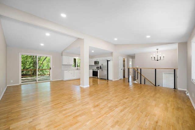 18120 27th Ave N, Plymouth, MN 55447 - unfurnished living room with a chandelier, lofted ceiling, light wood-type flooring, baseboards, and recessed lighting
