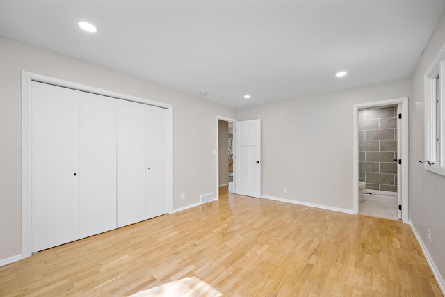 18120 27th Ave N, Plymouth, MN 55447 - unfurnished bedroom with light wood-style flooring, baseboards, ensuite bath, a closet, and recessed lighting