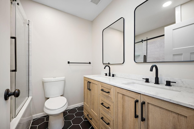 18120 27th Ave N, Plymouth, MN 55447 - full bathroom with toilet, double vanity, baseboards, enclosed tub / shower combo, and tile patterned floors