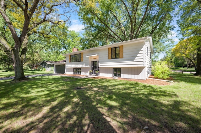18120 27th Ave N, Plymouth, MN 55447 - view of front of home featuring a chimney, an attached garage, and a front lawn