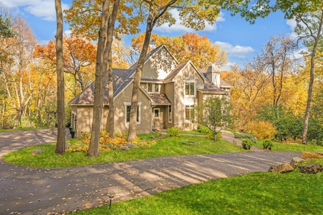 4266 Manor Court Rd, Minnetonka, MN 55345 - english style home with stucco siding, a chimney, a front yard, driveway, and stone siding