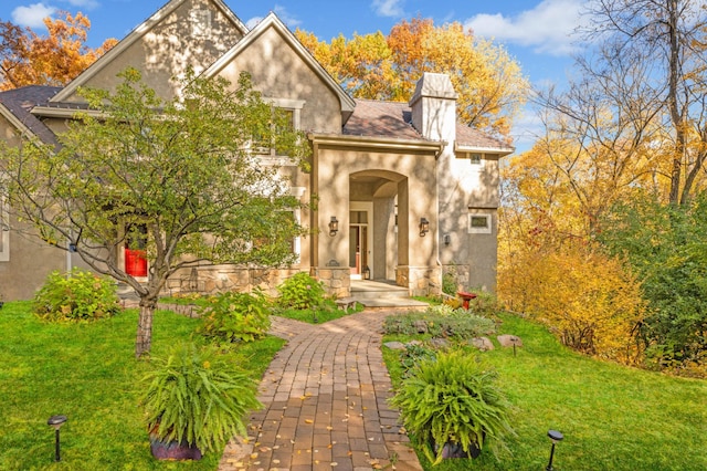 4266 Manor Court Rd, Minnetonka, MN 55345 - view of front of house featuring stucco siding and a front yard
