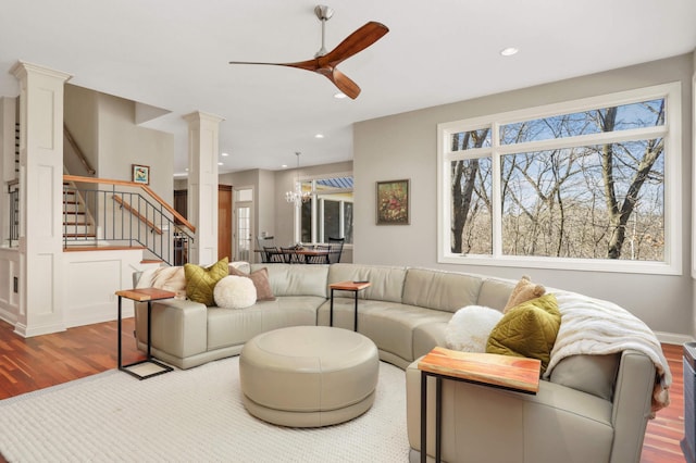 4266 Manor Court Rd, Minnetonka, MN 55345 - living area with stairs, ceiling fan, decorative columns, wood finished floors, and plenty of natural light