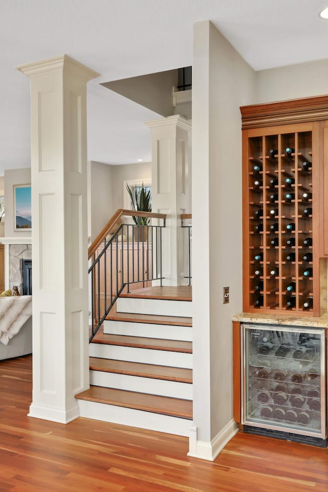 4266 Manor Court Rd, Minnetonka, MN 55345 - wine cellar with beverage cooler, wood finished floors, baseboards, and a fireplace
