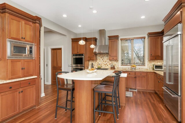 4266 Manor Court Rd, Minnetonka, MN 55345 - kitchen with built in appliances, wall chimney range hood, dark wood-type flooring, tasteful backsplash, and recessed lighting