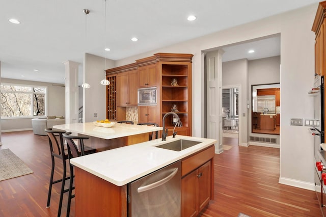 4266 Manor Court Rd, Minnetonka, MN 55345 - kitchen featuring a sink, appliances with stainless steel finishes, a center island with sink, dark wood-style floors, and recessed lighting