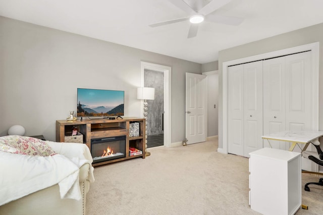 4266 Manor Court Rd, Minnetonka, MN 55345 - bedroom featuring light carpet, an office area, a closet, and a glass covered fireplace