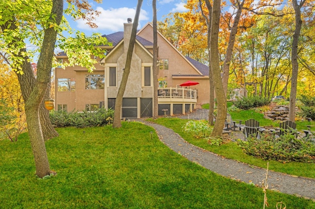 4266 Manor Court Rd, Minnetonka, MN 55345 - back of property with stucco siding, a lawn, a deck, and a chimney