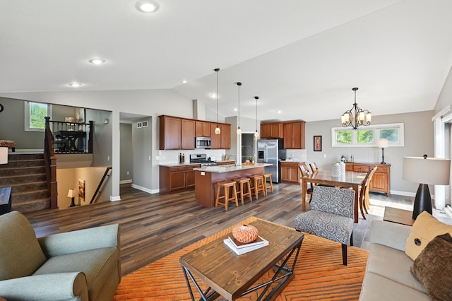 11350 97th Ave N, Maple Grove, MN 55369 - living room with vaulted ceiling, baseboards, a chandelier, dark wood-style floors, and stairway