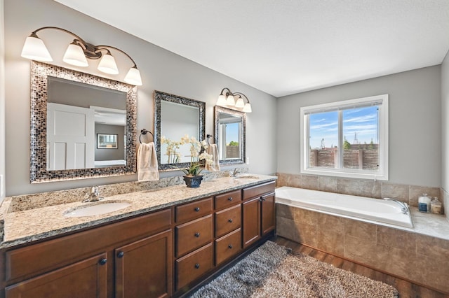 11350 97th Ave N, Maple Grove, MN 55369 - bathroom featuring double vanity, a bath, and wood finished floors