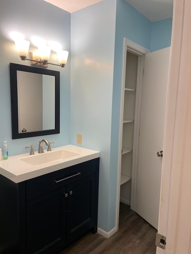 12232 Oak Leaf Cir, Burnsville, MN 55337 - bathroom featuring wood finished floors, vanity, and baseboards