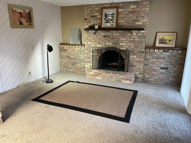 12232 Oak Leaf Cir, Burnsville, MN 55337 - unfurnished living room with carpet floors, a fireplace, and wooden walls