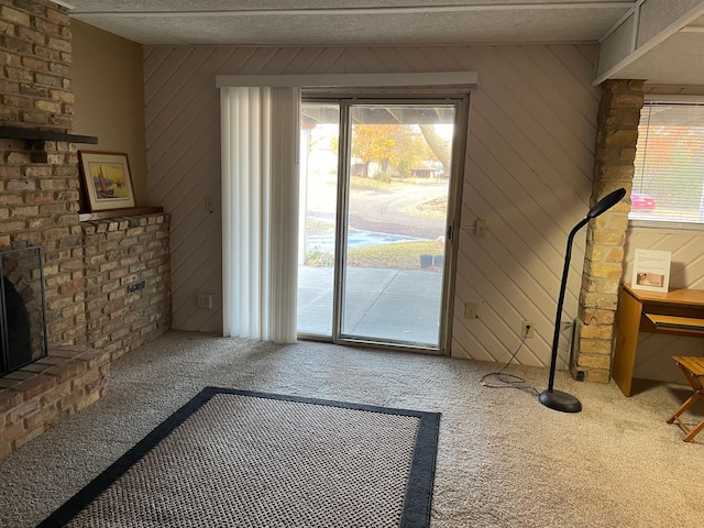 12232 Oak Leaf Cir, Burnsville, MN 55337 - doorway with carpet flooring, a brick fireplace, and wood walls