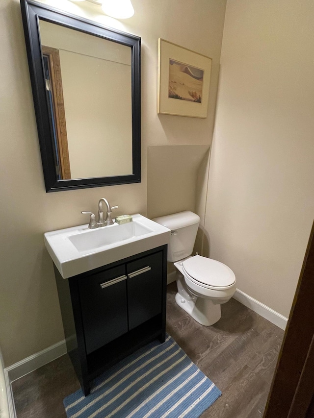 12232 Oak Leaf Cir, Burnsville, MN 55337 - half bath with toilet, vanity, wood finished floors, and baseboards