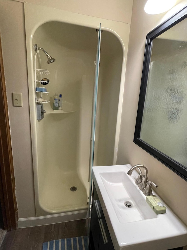 12232 Oak Leaf Cir, Burnsville, MN 55337 - bathroom with vanity, a shower stall, and wood finished floors