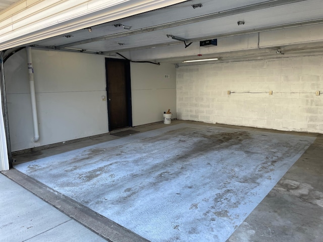 12232 Oak Leaf Cir, Burnsville, MN 55337 - garage with a garage door opener and concrete block wall