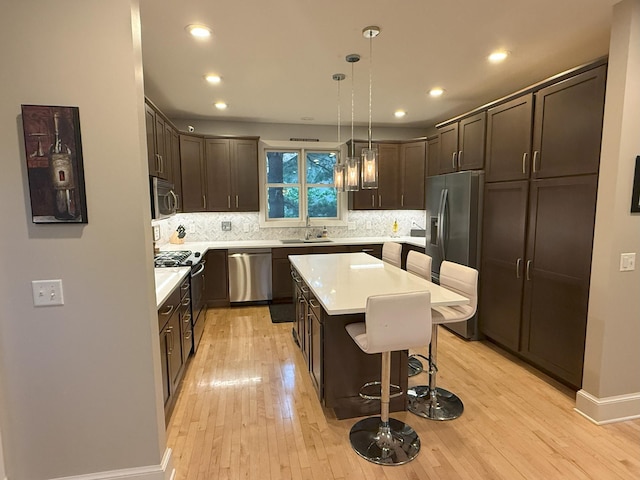4312 France Ave S, Edina, MN 55410 - kitchen with stainless steel appliances, dark brown cabinets, light countertops, and recessed lighting