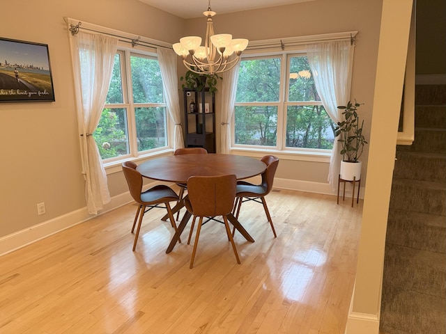 4312 France Ave S, Edina, MN 55410 - dining area with baseboards, a chandelier, plenty of natural light, and light wood-style flooring