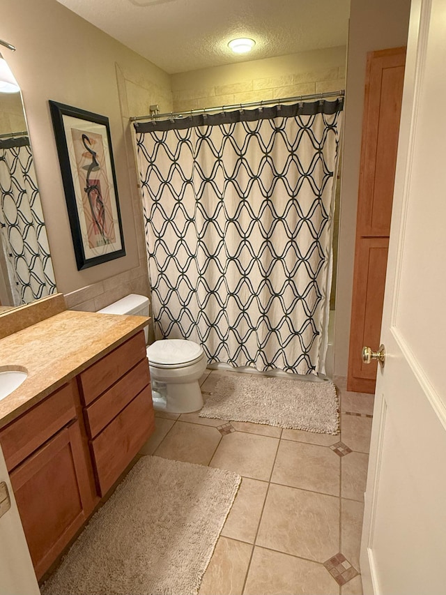 4312 France Ave S, Edina, MN 55410 - bathroom featuring vanity, tile patterned flooring, toilet, and a textured ceiling