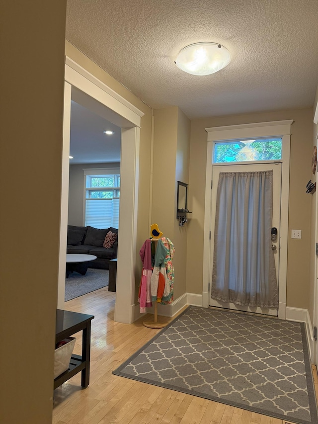 4312 France Ave S, Edina, MN 55410 - entryway featuring wood finished floors, baseboards, and a textured ceiling