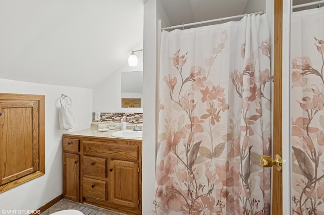 220 State St, Belle Plaine, MN 56011 - bathroom featuring vanity, decorative backsplash, lofted ceiling, and a shower with shower curtain