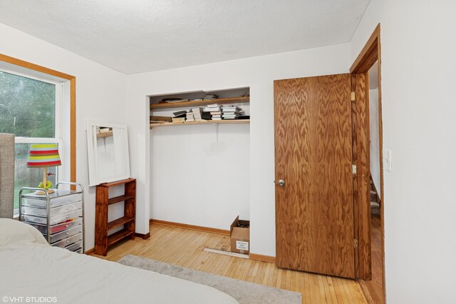 220 State St, Belle Plaine, MN 56011 - bedroom featuring hardwood / wood-style flooring, baseboards, and a closet