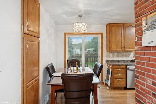 220 State St, Belle Plaine, MN 56011 - dining area featuring light wood finished floors and a chandelier