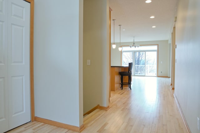 4629 Empress Way N, Hugo, MN 55038 - hall with light wood finished floors, baseboards, recessed lighting, and a chandelier