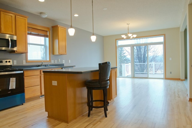 4629 Empress Way N, Hugo, MN 55038 - kitchen with stainless steel appliances, a center island, plenty of natural light, light wood-style floors, and recessed lighting