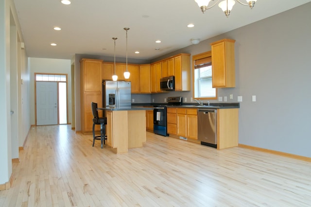 4629 Empress Way N, Hugo, MN 55038 - kitchen with appliances with stainless steel finishes, dark countertops, light wood-type flooring, plenty of natural light, and recessed lighting