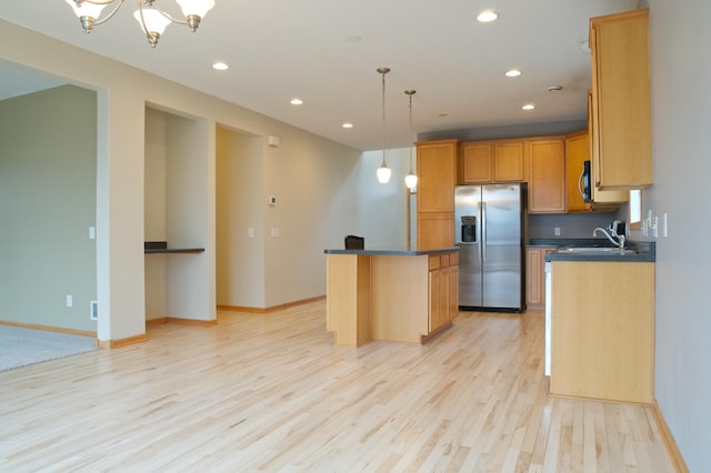 4629 Empress Way N, Hugo, MN 55038 - kitchen with stainless steel fridge with ice dispenser, light wood-style floors, dark countertops, recessed lighting, and a center island