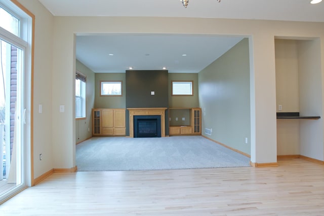 4629 Empress Way N, Hugo, MN 55038 - unfurnished living room featuring light wood-type flooring, baseboards, a fireplace, and recessed lighting