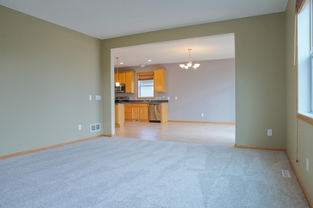 4629 Empress Way N, Hugo, MN 55038 - unfurnished living room featuring a chandelier, light colored carpet, baseboards, recessed lighting, and a sink