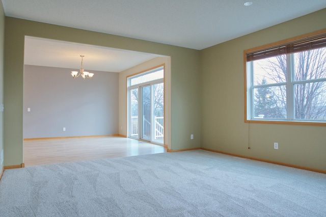 4629 Empress Way N, Hugo, MN 55038 - carpeted empty room featuring a chandelier and baseboards