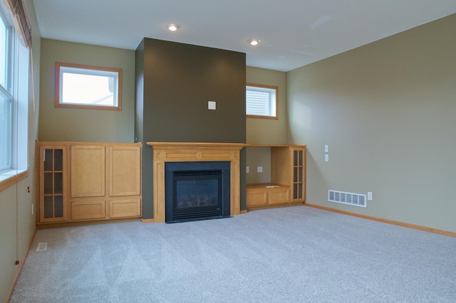 4629 Empress Way N, Hugo, MN 55038 - unfurnished living room with carpet floors, baseboards, a fireplace with flush hearth, and recessed lighting