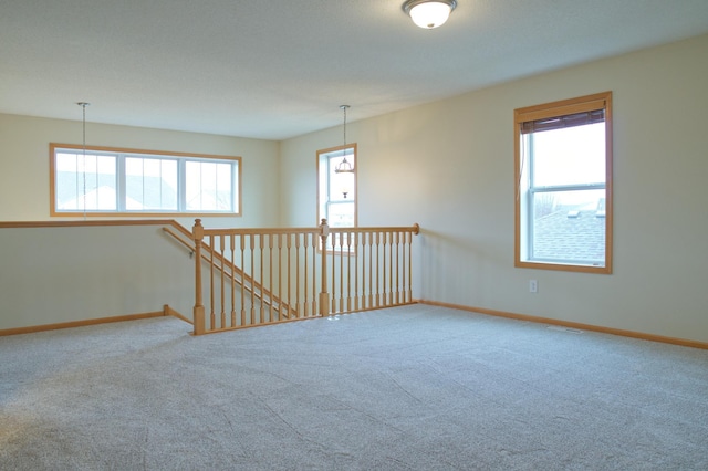 4629 Empress Way N, Hugo, MN 55038 - empty room featuring carpet flooring, plenty of natural light, and baseboards