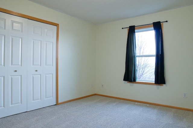 4629 Empress Way N, Hugo, MN 55038 - unfurnished bedroom featuring light carpet, baseboards, and a closet