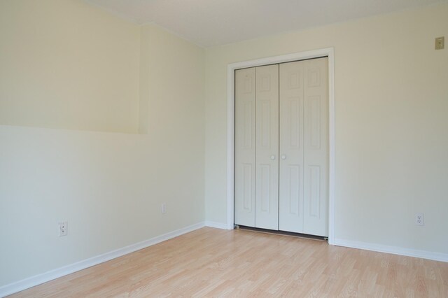 4629 Empress Way N, Hugo, MN 55038 - unfurnished bedroom featuring light wood-style floors, a closet, and baseboards