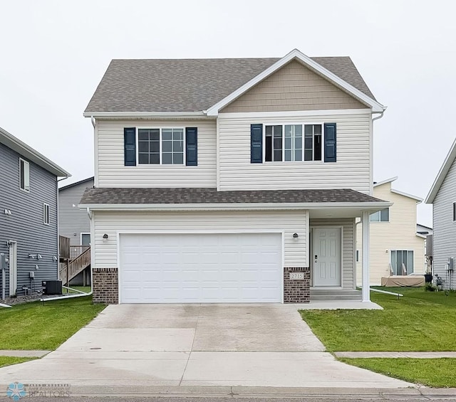 2715 11th St W, West Fargo, ND 58078 - view of front of home featuring brick siding, driveway, a front lawn, and a garage