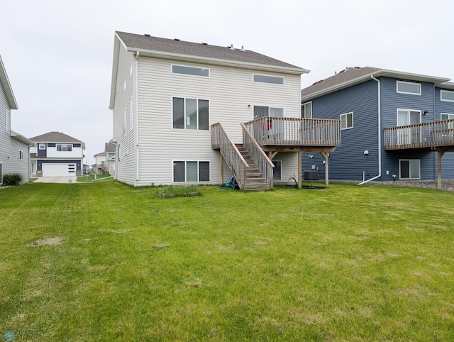 2715 11th St W, West Fargo, ND 58078 - rear view of house with stairs, a wooden deck, and a yard