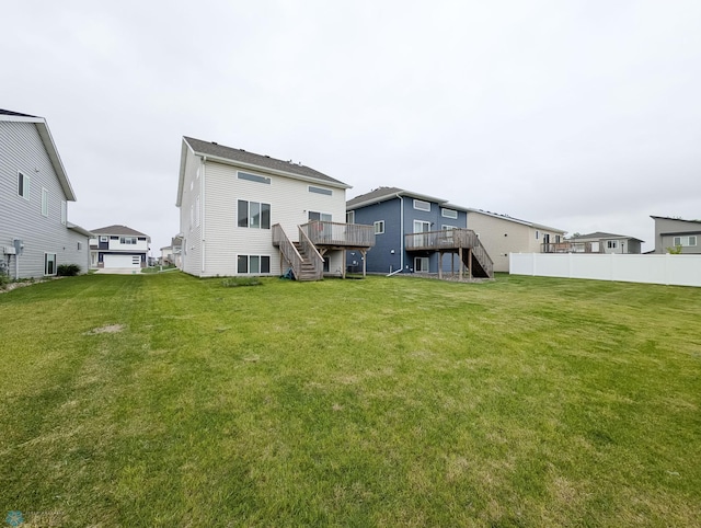 2715 11th St W, West Fargo, ND 58078 - rear view of property with stairway, a deck, and a yard