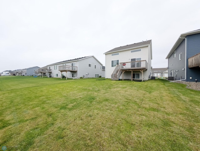 2715 11th St W, West Fargo, ND 58078 - rear view of house with stairway, a wooden deck, a lawn, and a residential view