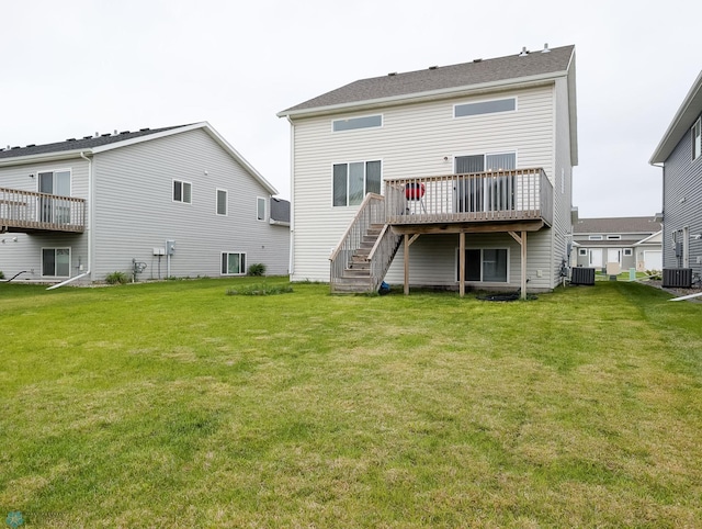 2715 11th St W, West Fargo, ND 58078 - rear view of house featuring a wooden deck, a lawn, and stairs