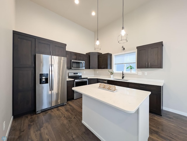 2715 11th St W, West Fargo, ND 58078 - kitchen featuring appliances with stainless steel finishes, high vaulted ceiling, dark wood-type flooring, hanging light fixtures, and a kitchen island