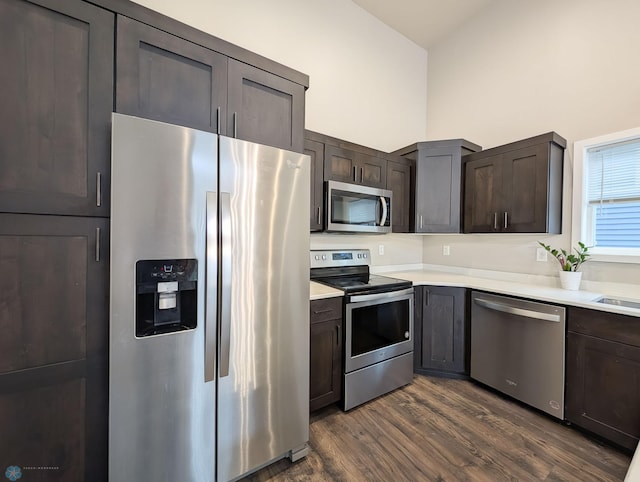 2715 11th St W, West Fargo, ND 58078 - kitchen with appliances with stainless steel finishes, light countertops, dark wood-style flooring, and dark brown cabinets