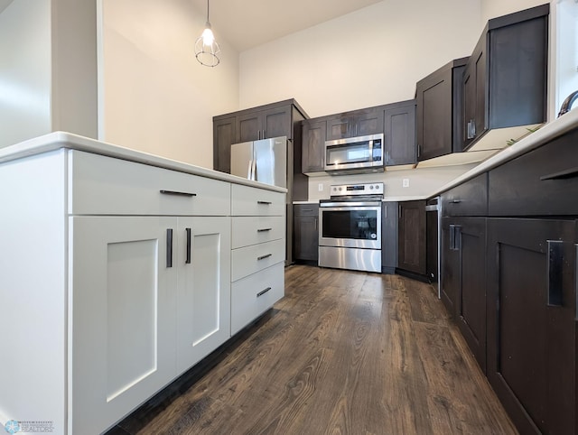 2715 11th St W, West Fargo, ND 58078 - kitchen featuring stainless steel appliances, dark wood finished floors, light countertops, dark brown cabinets, and pendant lighting