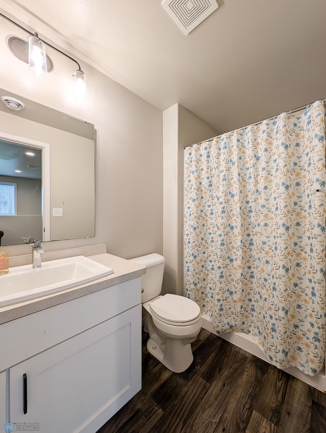 2715 11th St W, West Fargo, ND 58078 - full bathroom featuring wood finished floors, vanity, and curtained shower